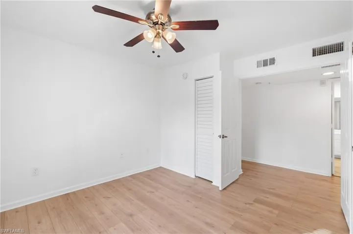 Unfurnished bedroom with a closet, ceiling fan, and light wood-type flooring