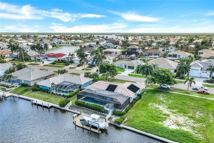 Birds eye view of property with a water view