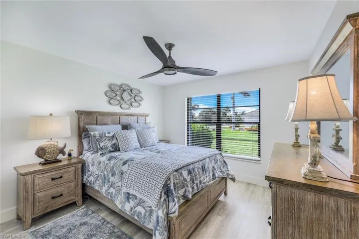 Bedroom with ceiling fan and light wood-type flooring