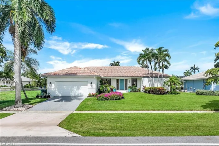 Ranch-style house with a garage and a front yard