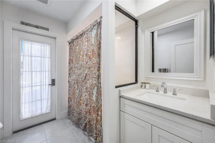 Bathroom featuring tile floors and vanity with extensive cabinet space