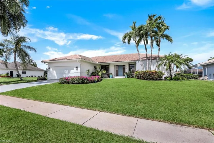 View of front of home featuring a garage and a front lawn