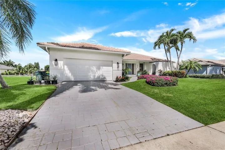 View of front of house featuring a garage and a front yard