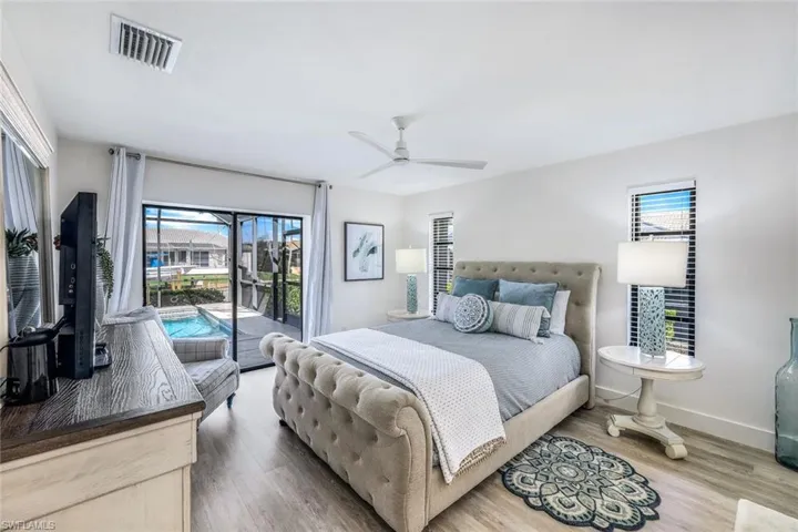 Bedroom featuring access to outside, hardwood / wood-style flooring, and ceiling fan
