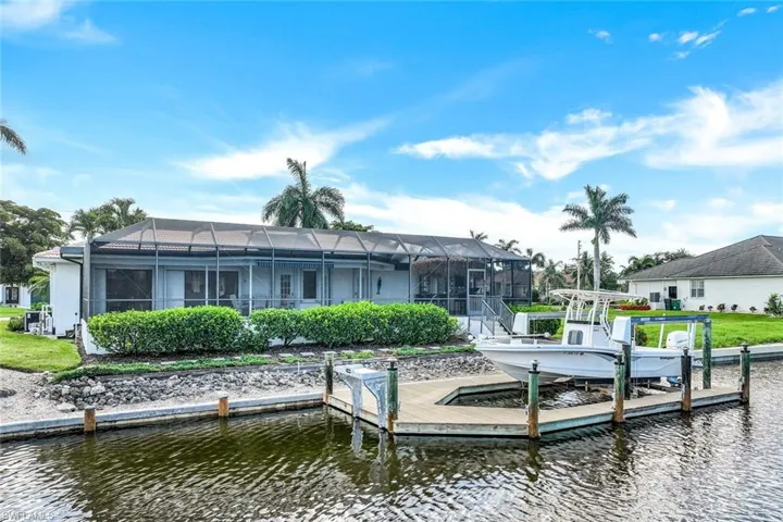 Dock area featuring glass enclosure and a water view