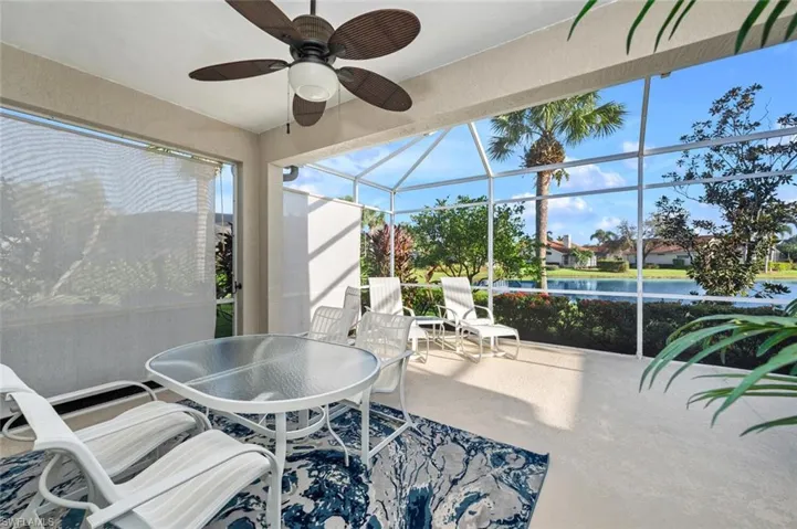 Sunroom / solarium with a water view and ceiling fan