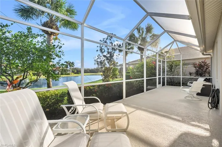 Sunroom featuring a water view
