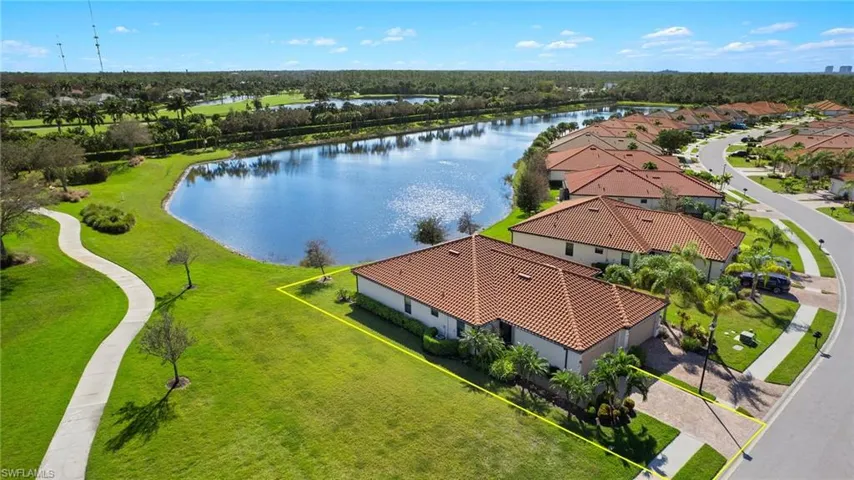 Aerial view featuring corner lot, walking path and beautiful lake views.