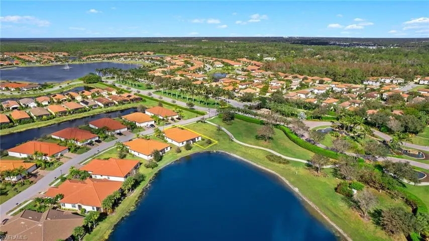 Aerial view featuring corner lot, walking path and beautiful lake views.