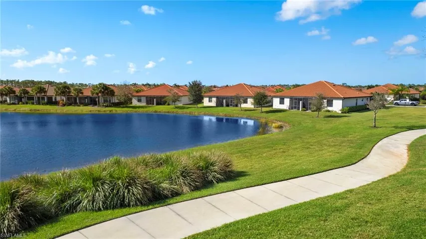 Aerial view featuring corner lot, walking path and beautiful lake views.