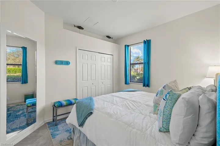 Guest Bedroom with a King size bed, a large closet, light tile floors, and plenty of sunshine.