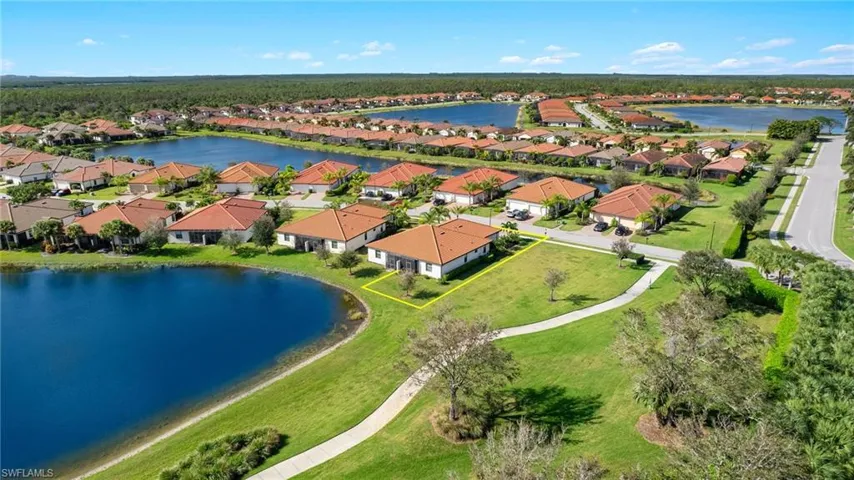 Aerial view featuring corner lot, walking path and beautiful lake views.