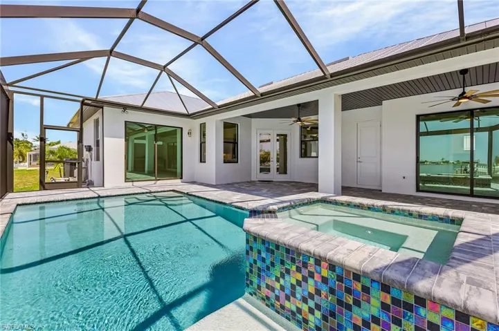 View of swimming pool featuring an in ground hot tub, a patio, french doors, and ceiling fan