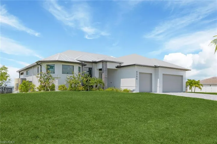 View of front of home featuring a garage and a front yard