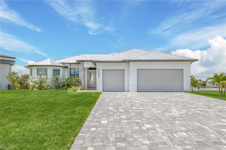 View of front of house featuring a garage and a front yard