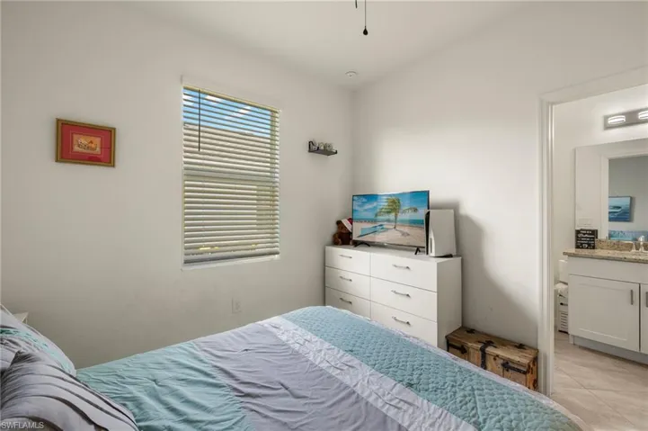 Bedroom with light tile patterned flooring