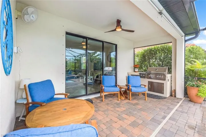 View of patio with area for grilling, ceiling fan, and an outdoor kitchen