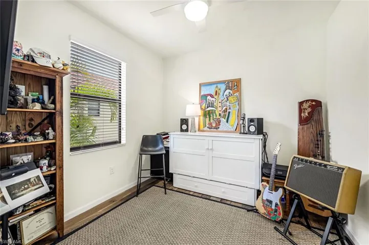 Miscellaneous room with ceiling fan and wood-type flooring