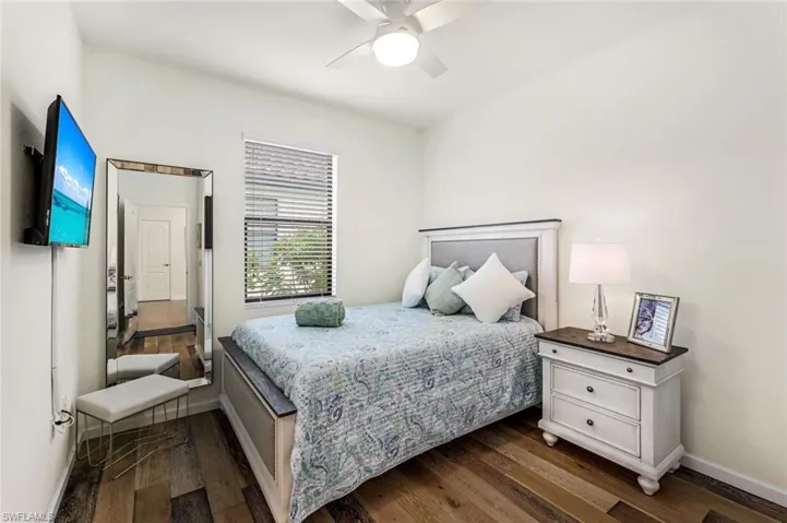Bedroom featuring ceiling fan and dark hardwood / wood-style floors