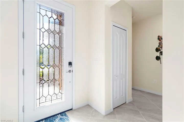 Foyer with light tile patterned floors