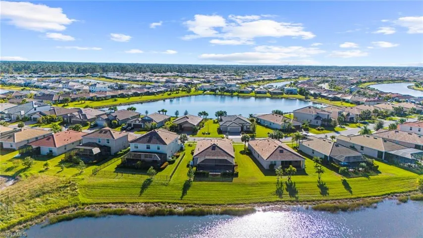 Birds eye view of property with a water view