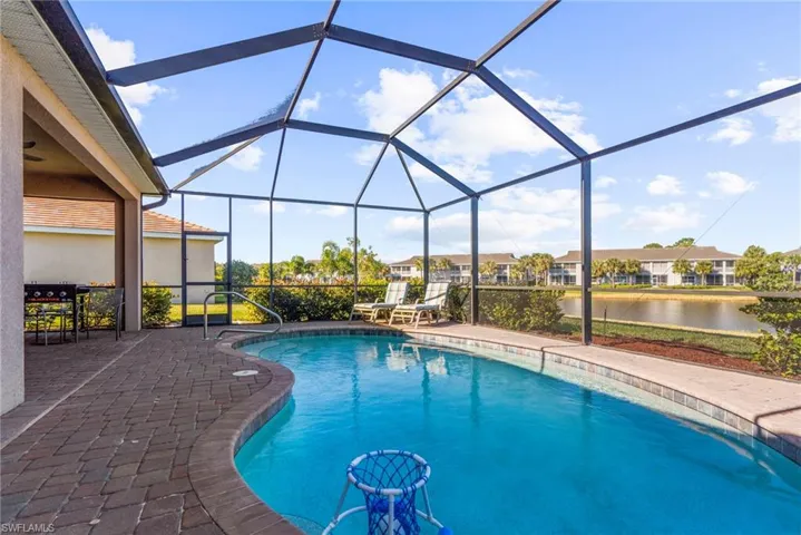 View of pool featuring a lanai, a water view, and a patio