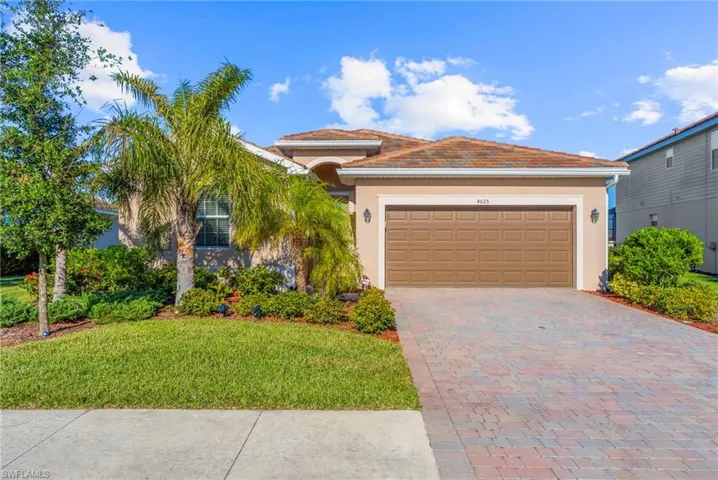 View of front of house with a front lawn and a garage