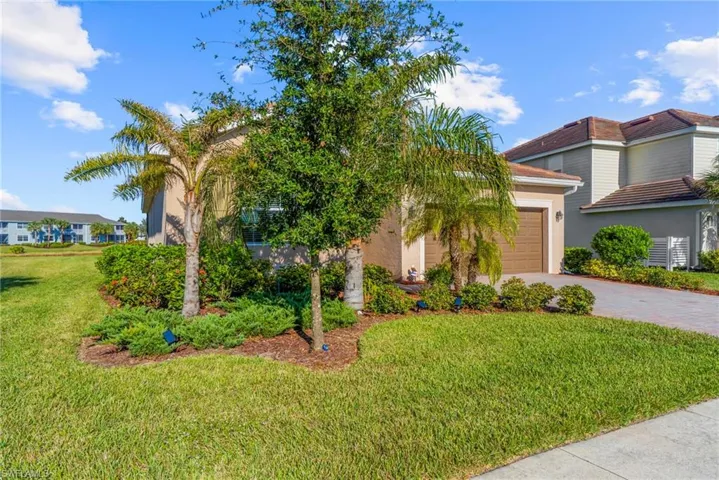 View of front of home with a garage and a front yard