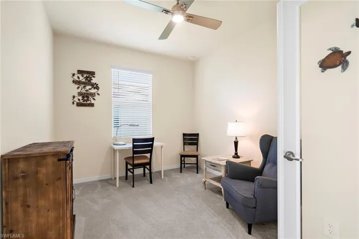 Sitting room with light carpet and ceiling fan