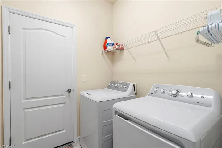 Washroom featuring washing machine and clothes dryer