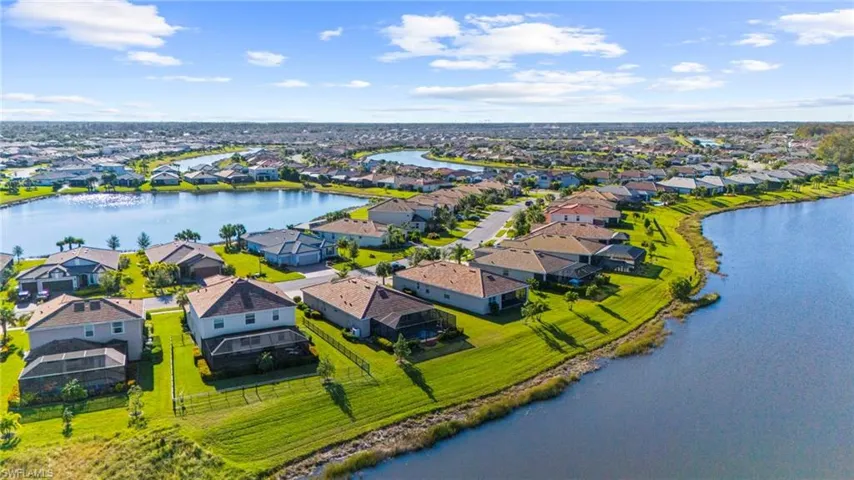 Birds eye view of property with a water view