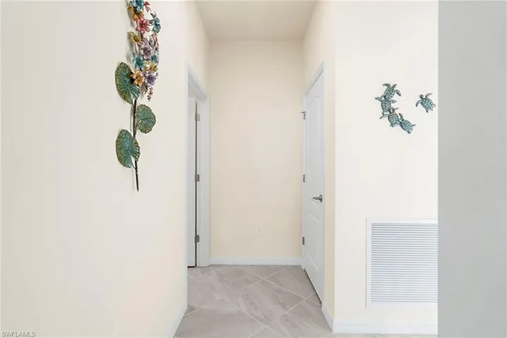 Hall with light tile patterned flooring