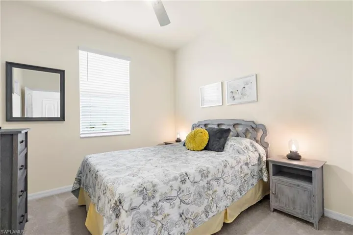Carpeted bedroom with ceiling fan