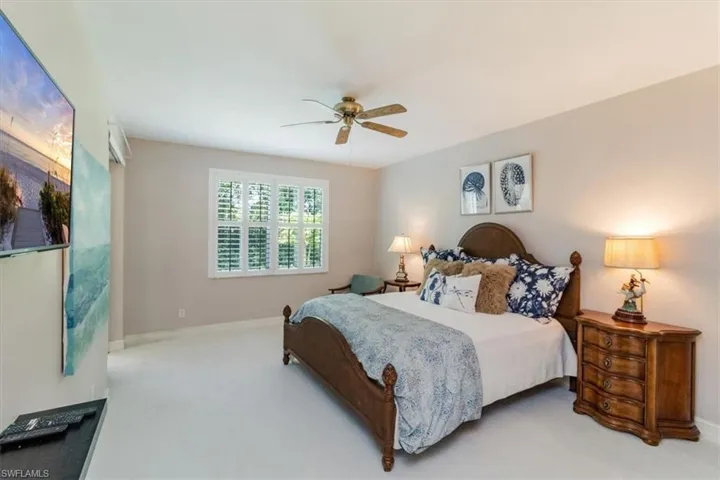 Large master bedroom featuring new white linen carpet leading our to four season lanai.