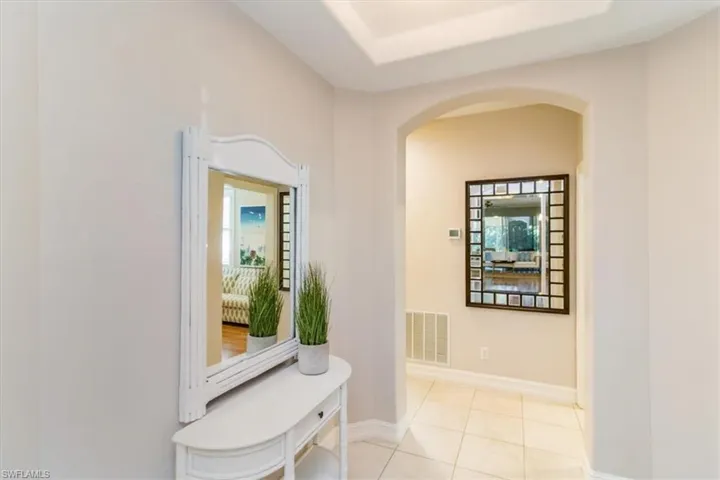 Hallway with a wealth of natural light and light tile flooring