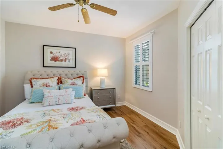 Guest edroom featuring a closet, wood laminate flooring, beautiful views of the courtyard