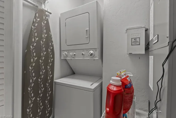 Washroom with stacked washing maching and dryer