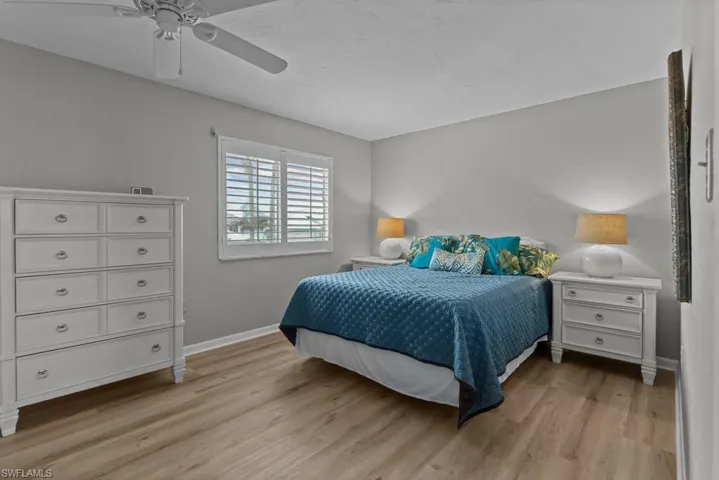 Bedroom featuring ceiling fan and light hardwood / wood-style flooring