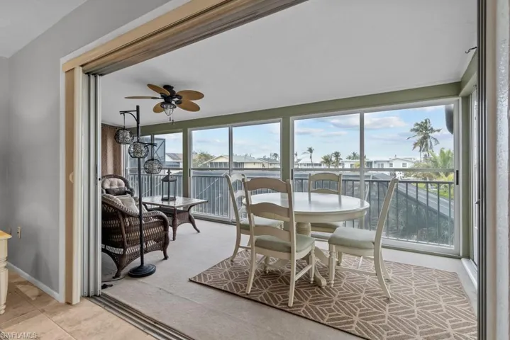 Sunroom / solarium featuring ceiling fan