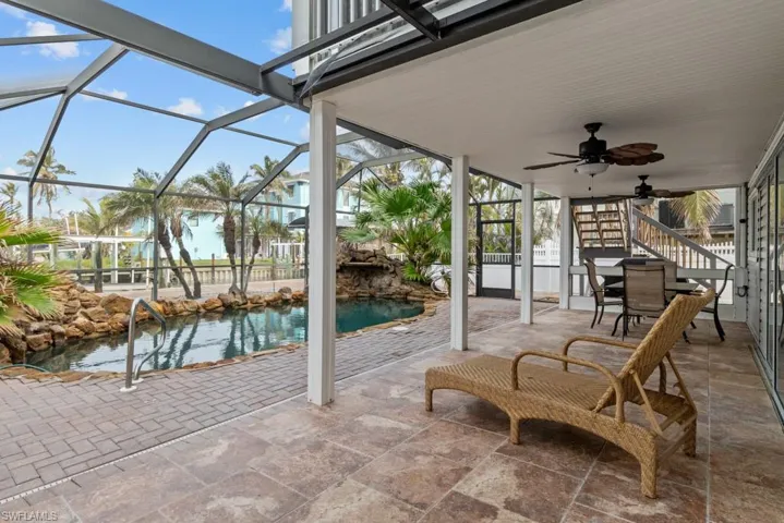 View of patio / terrace featuring ceiling fan and a lanai