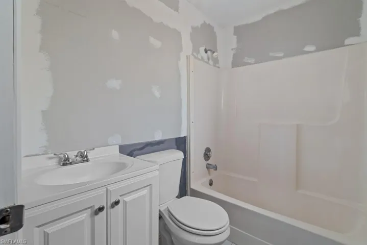 Full bathroom featuring vanity,  shower combination, and toilet