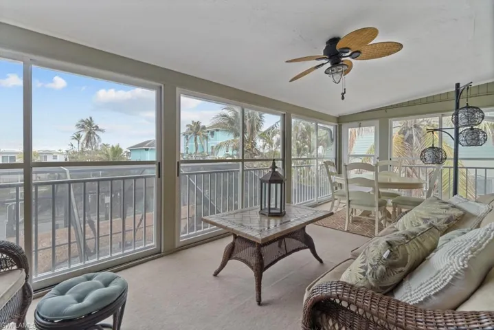 Sunroom featuring lofted ceiling and ceiling fan