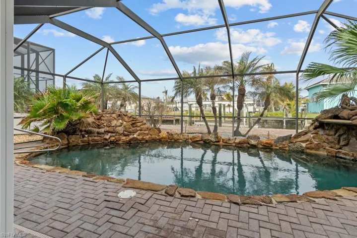 View of swimming pool with a lanai