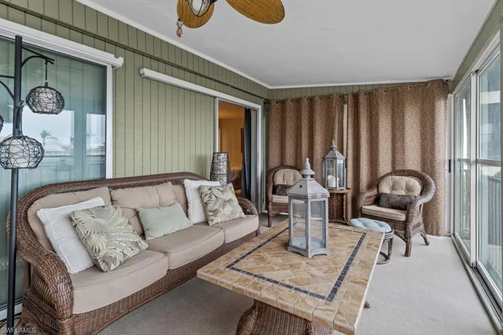 Sunroom / solarium with ceiling fan and a baseboard heating unit