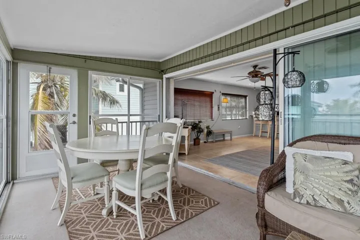 Sunroom featuring ceiling fan