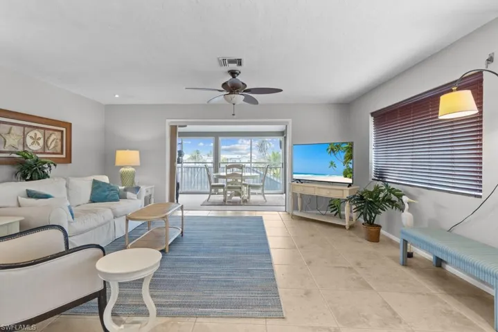 Living room featuring ceiling fan and light tile patterned floors