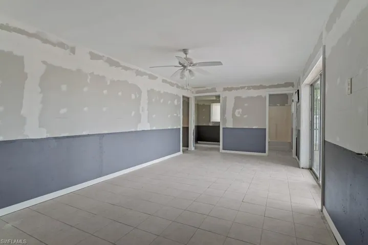 Empty room featuring light tile patterned floors and ceiling fan