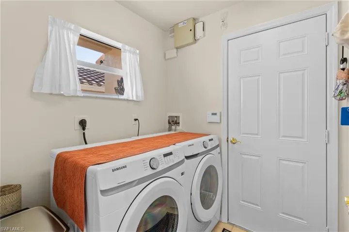 Clothes washing area featuring washing machine and dryer