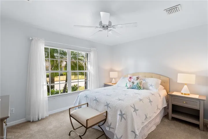 Carpeted bedroom with ceiling fan