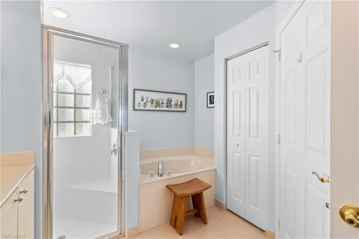 Bathroom with vanity, tile patterned floors, and separate shower and tub